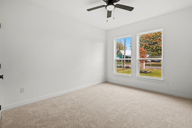 spare room featuring ceiling fan and carpet floors