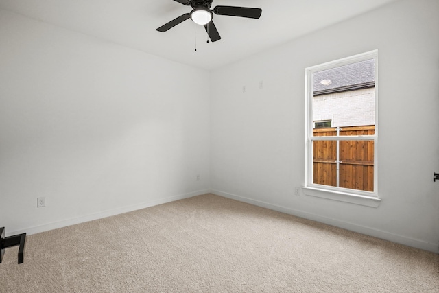 empty room featuring ceiling fan and carpet floors