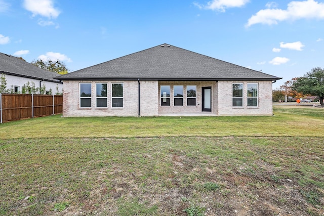 rear view of house with a yard