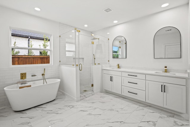 bathroom featuring shower with separate bathtub, vanity, and tile walls