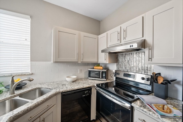 kitchen with tasteful backsplash, sink, stainless steel appliances, and white cabinets