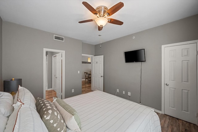 bedroom with ceiling fan and dark hardwood / wood-style flooring