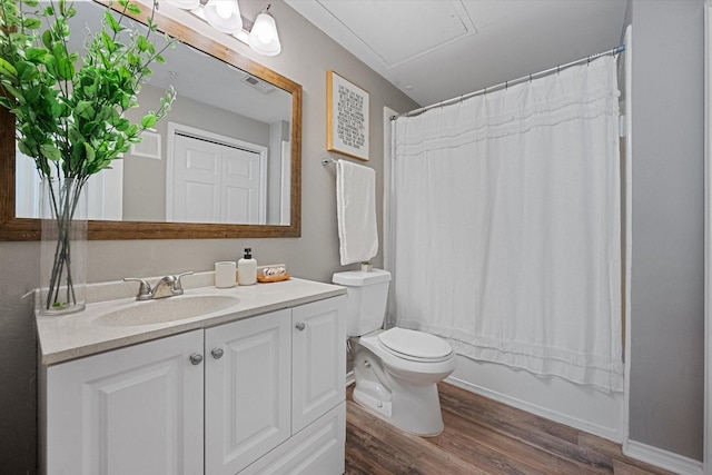 full bathroom with vanity, toilet, hardwood / wood-style floors, and shower / bath combo