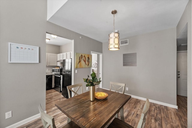 dining room with wood-type flooring