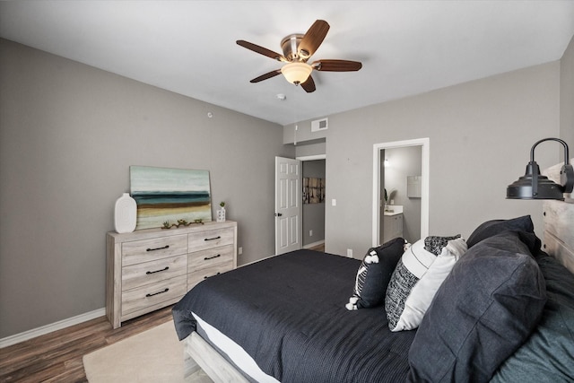 bedroom featuring dark hardwood / wood-style floors, connected bathroom, and ceiling fan