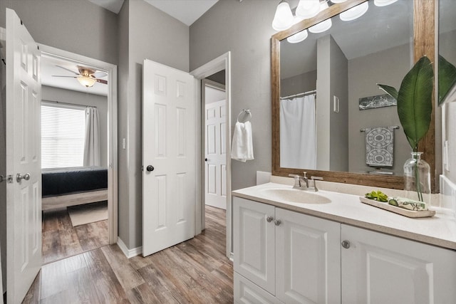 bathroom with vanity, hardwood / wood-style flooring, and ceiling fan