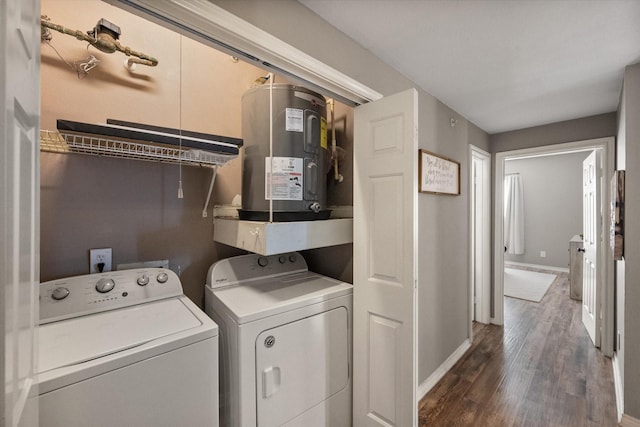 clothes washing area featuring electric water heater, washing machine and clothes dryer, and dark hardwood / wood-style flooring