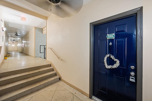 doorway to property featuring ceiling fan