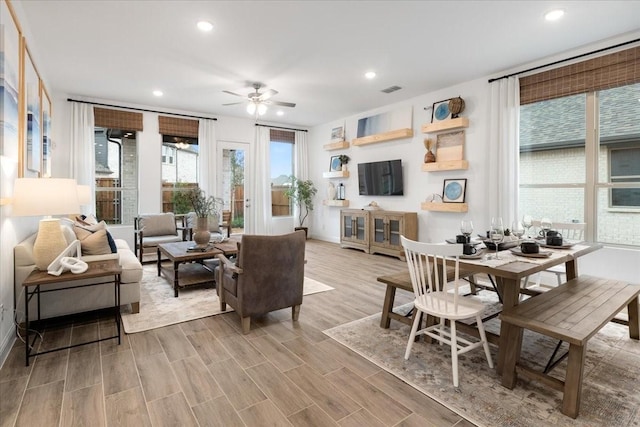 living room with ceiling fan and light wood-type flooring