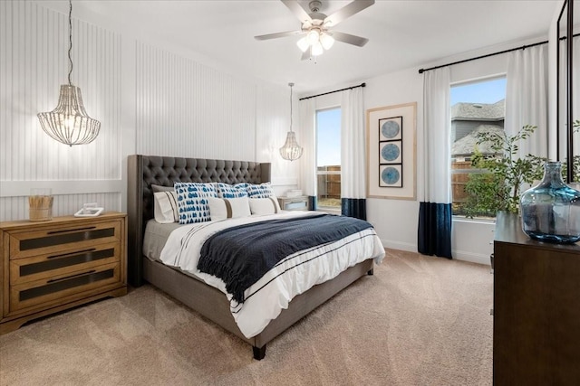 bedroom featuring light carpet and ceiling fan