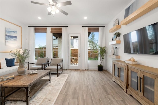 living room featuring ceiling fan and light wood-type flooring