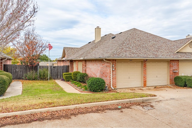 exterior space featuring a front lawn and a garage