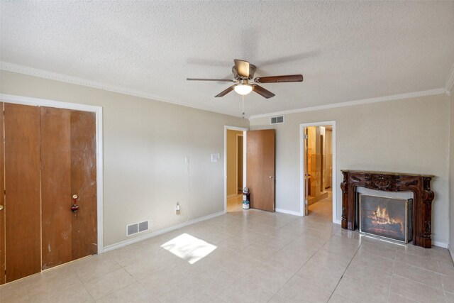 unfurnished living room featuring light tile patterned floors, a textured ceiling, ceiling fan, and ornamental molding