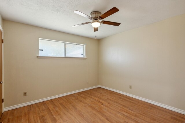 spare room with ceiling fan, a textured ceiling, and light hardwood / wood-style flooring