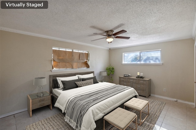 bedroom featuring ceiling fan, a textured ceiling, and ornamental molding