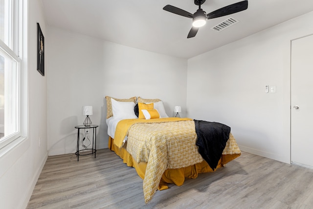 bedroom with light hardwood / wood-style floors and ceiling fan