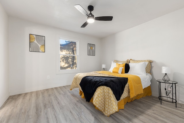 bedroom with light wood-type flooring and ceiling fan