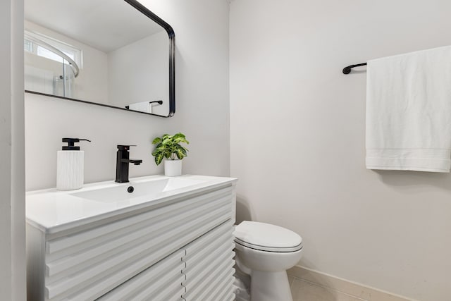 bathroom featuring tile patterned floors, vanity, and toilet