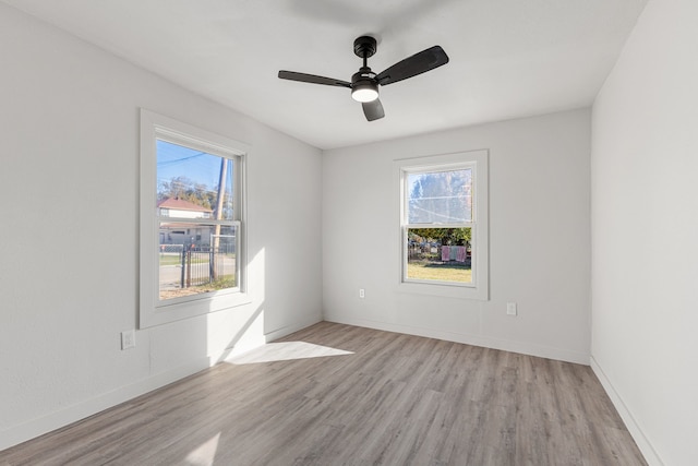 spare room with light hardwood / wood-style flooring and ceiling fan