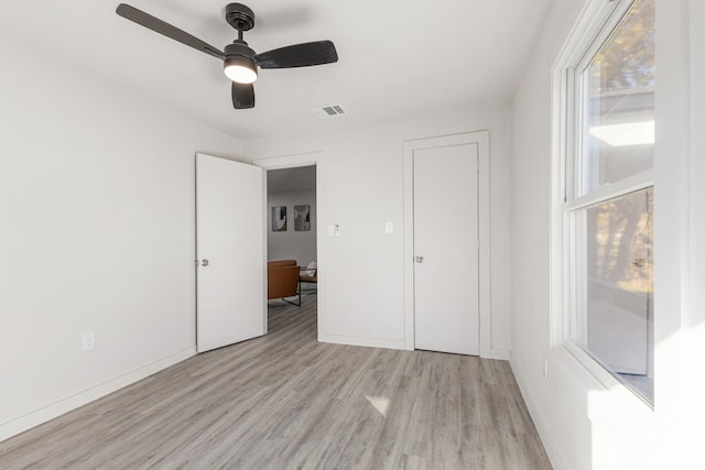 unfurnished bedroom with ceiling fan and light hardwood / wood-style floors