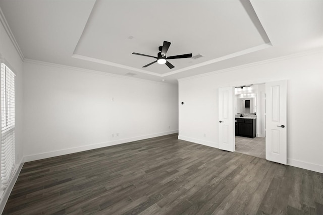 interior space with ceiling fan, dark hardwood / wood-style flooring, and a raised ceiling