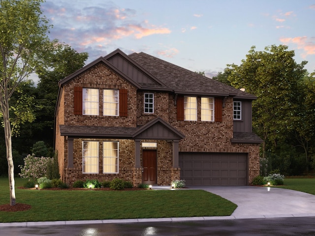 view of front of house featuring a garage and a yard