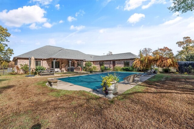 view of swimming pool featuring a patio area and a yard