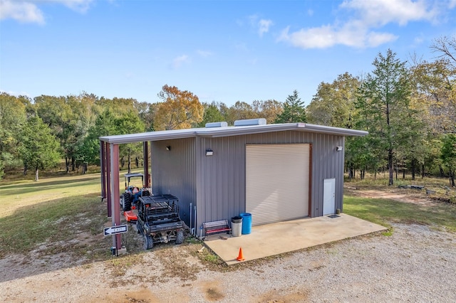 view of outbuilding featuring a lawn and a garage