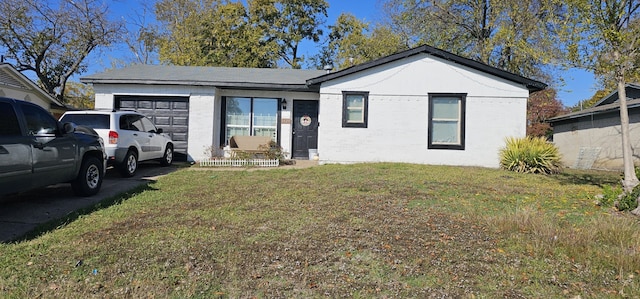 view of front of home featuring a garage and a front lawn