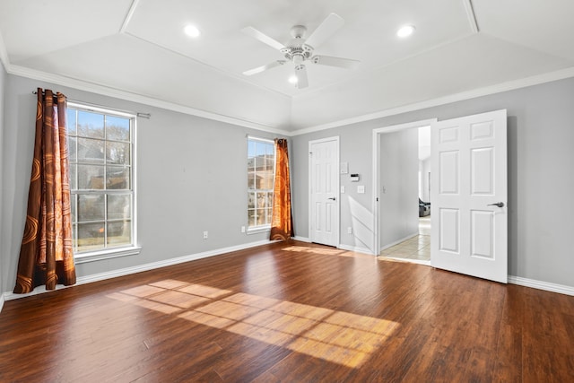 empty room featuring crown molding, ceiling fan, wood-type flooring, and vaulted ceiling