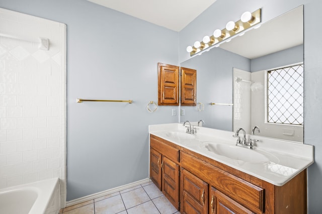 full bathroom with tile patterned floors, double vanity, baseboards, and a sink