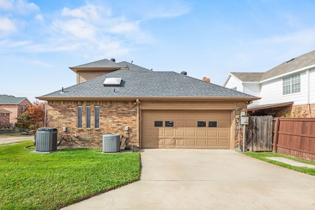 exterior space with central air condition unit, a yard, driveway, and roof with shingles