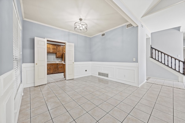 unfurnished room with stairs, visible vents, and ornamental molding