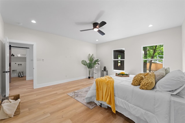 bedroom with light hardwood / wood-style floors and ceiling fan