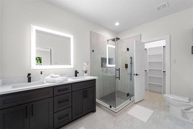 bathroom featuring vanity, toilet, and walk in shower