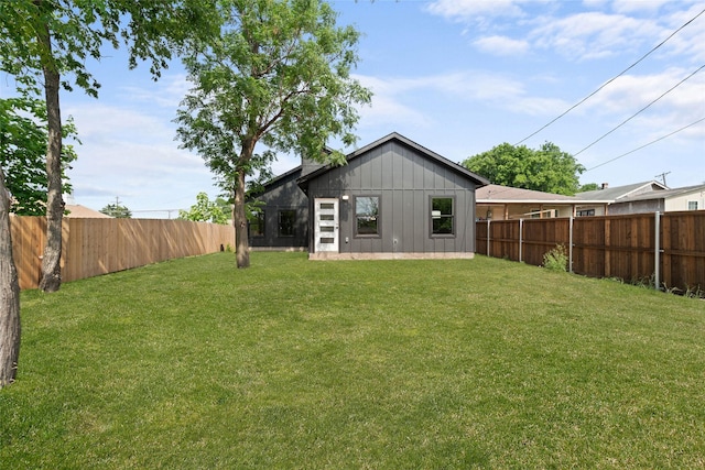 rear view of house with a yard