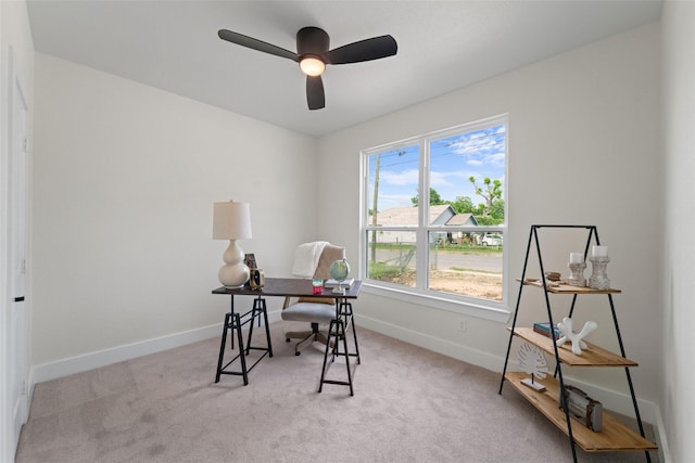 carpeted office space featuring ceiling fan