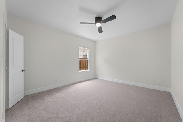 spare room with light carpet and ceiling fan