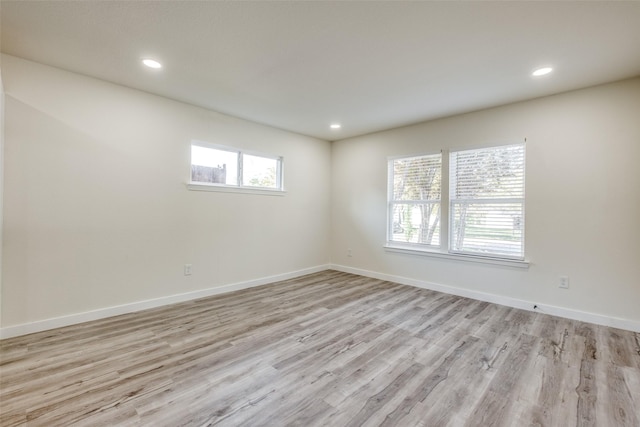 empty room with light hardwood / wood-style floors