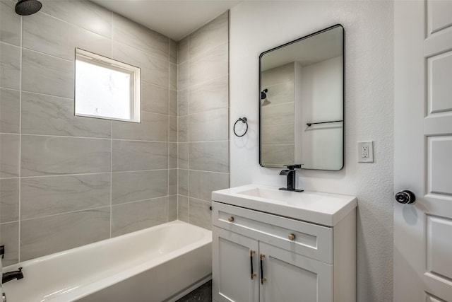 bathroom featuring vanity and tiled shower / bath combo