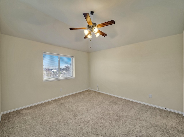 spare room with light carpet and ceiling fan