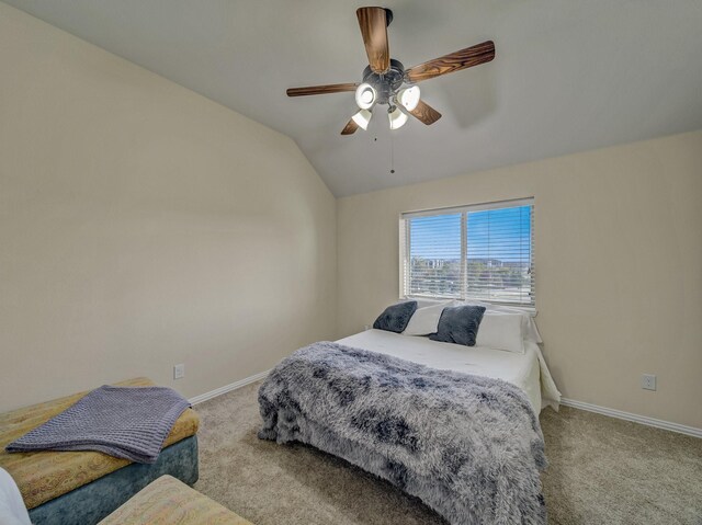 carpeted bedroom featuring lofted ceiling and ceiling fan