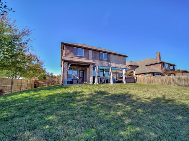 rear view of property with a yard and a pergola