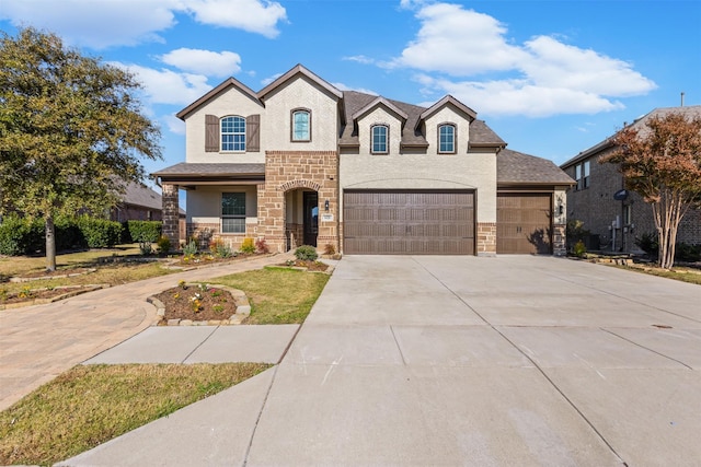 french provincial home with a garage