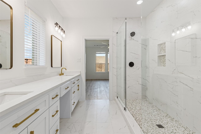 bathroom featuring ceiling fan, vanity, and tiled shower