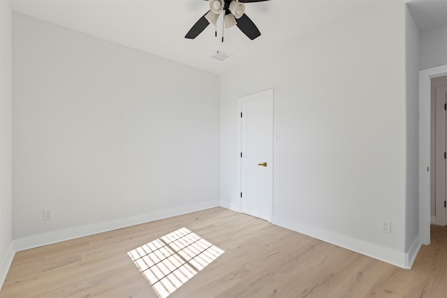 spare room featuring light hardwood / wood-style flooring and ceiling fan