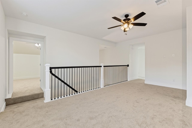 unfurnished room featuring light carpet and ceiling fan