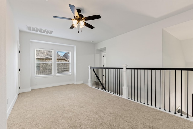 empty room with light colored carpet and ceiling fan