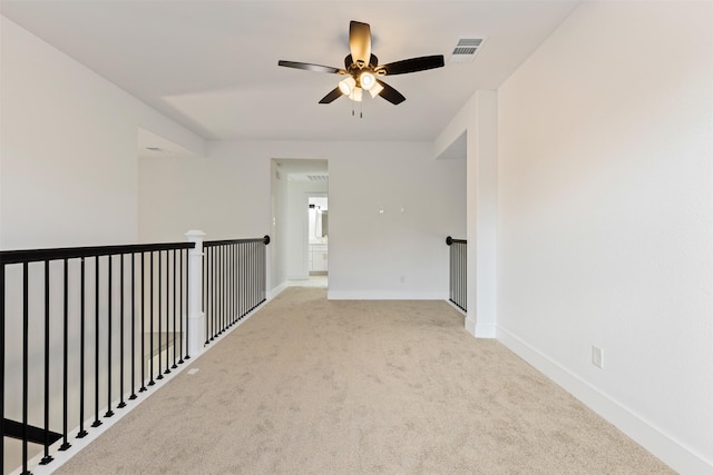 hallway featuring light carpet