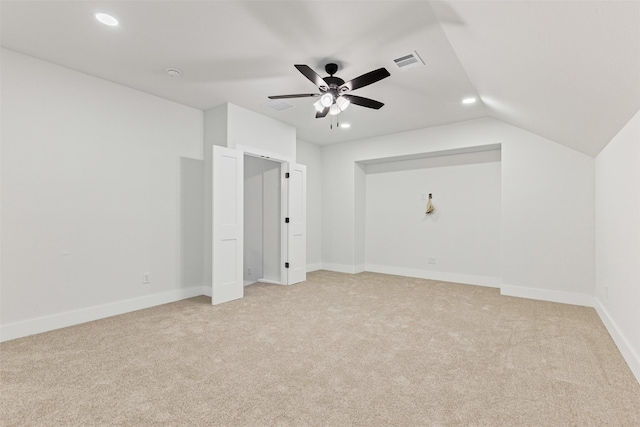 additional living space with light carpet, ceiling fan, and vaulted ceiling